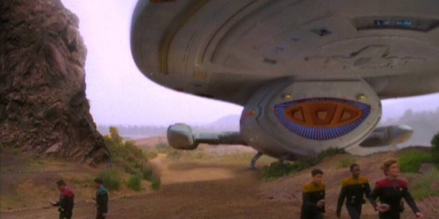 The USS Voyager landed on a planet with the crew in the foreground from Star Trek: Voyager season 2, episode 1, 