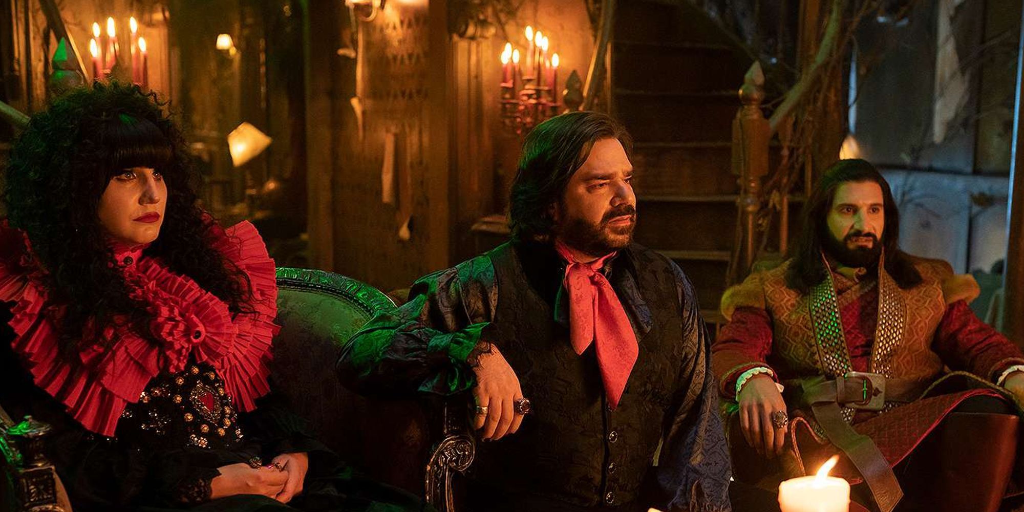 Natasia Demetriou, Matt Berry, and Kayvan Novak as Nadja, Lazslo, and Nandor sitting and looking attentively in What We Do in The Shadows