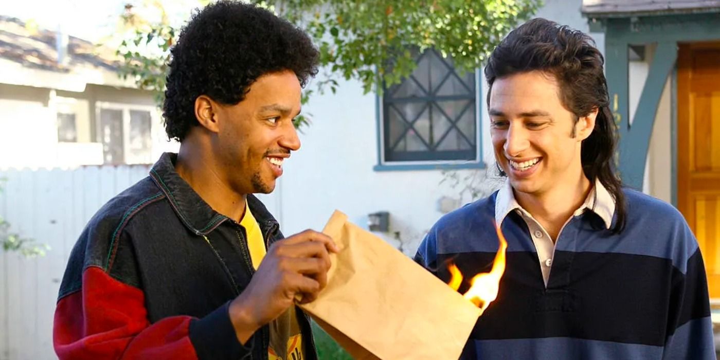 A young JD and Turk smiling together while holding a flaming paper bag