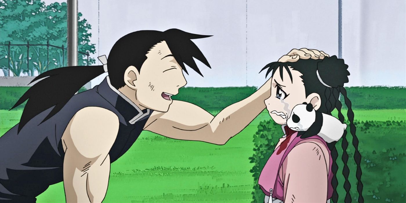 A man pats the head of a crying girl with a small panda on her shoulder.