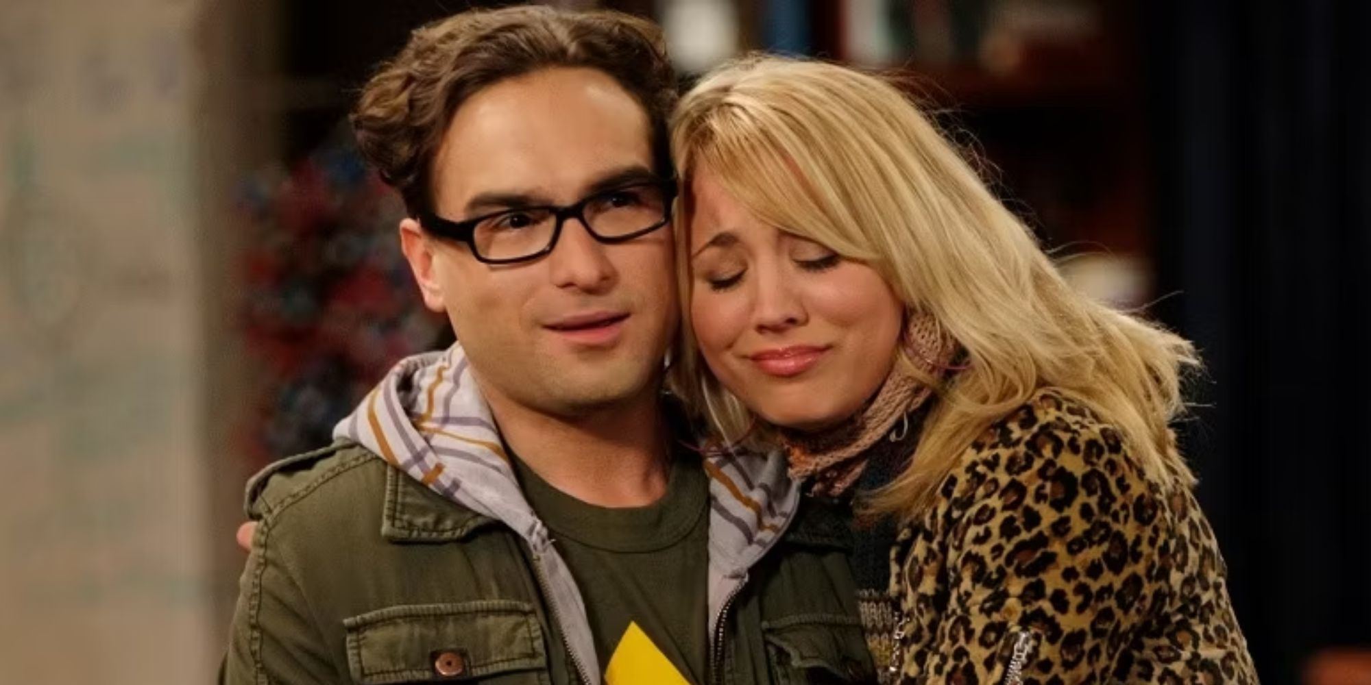 Kaley Cuoco as Penny snuggling up to Johnny Galecki as Leonard in The Big Bang Theory