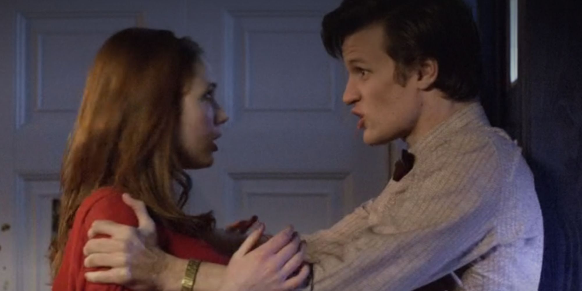 Matt Smith as the Eleventh Doctor in Doctor Who holding Karen Gillan's Amy Pond at arm's length
