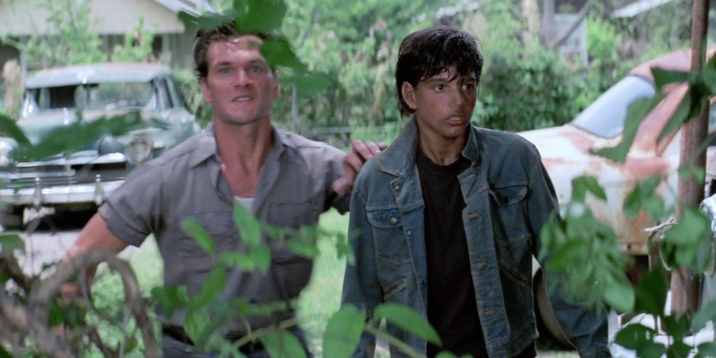 Darry looking angry and Johnny looking distraught in The Outsiders