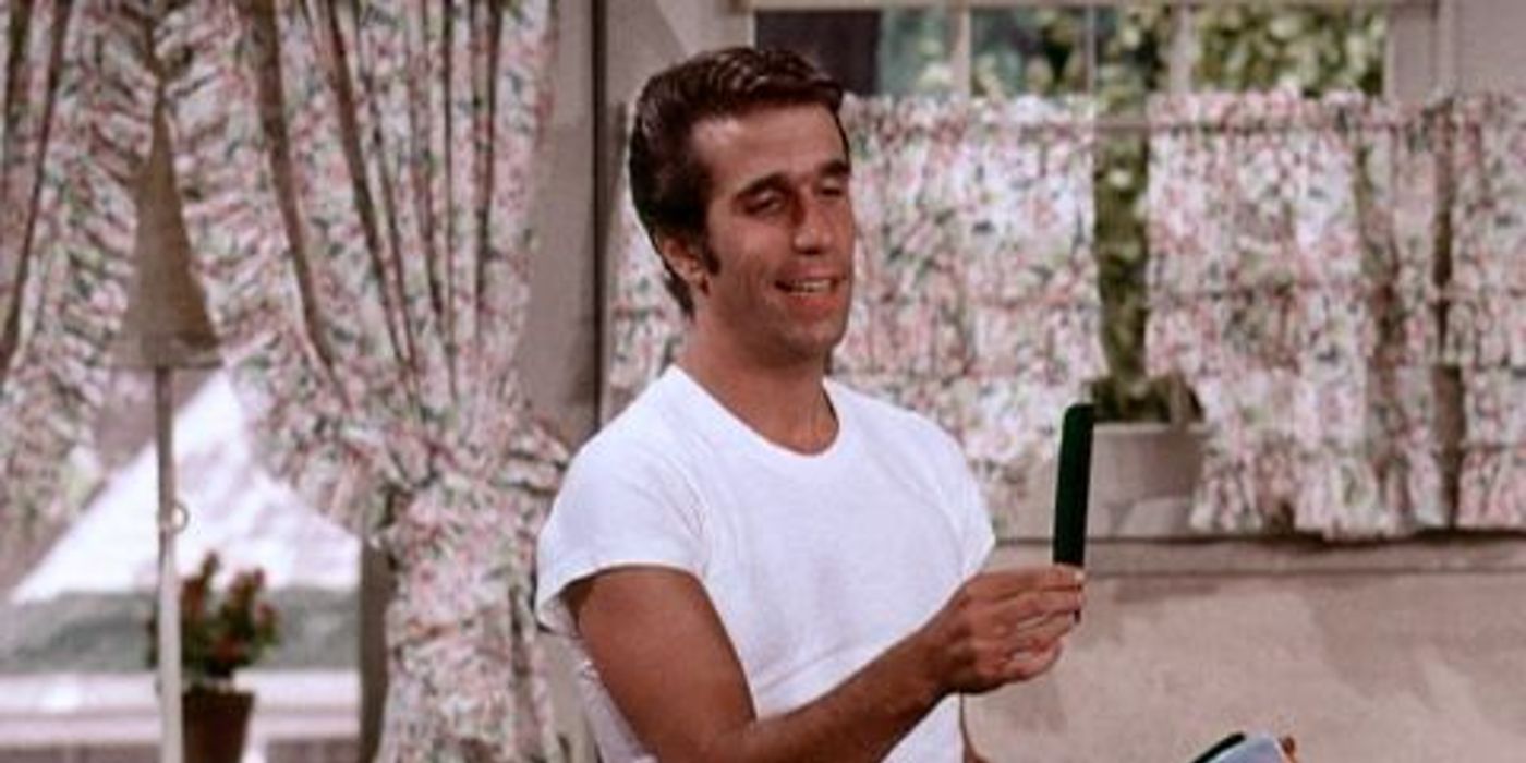 Henry Winkler as Fonzie holding up an object in Happy Days