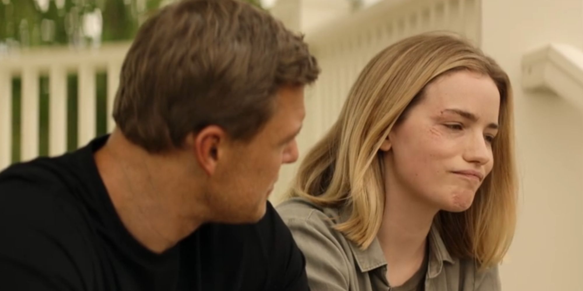 Ben Ritchson as Reacher looking at a pondering Willa Fitzgerald as Roscoe Conklin in Reacher