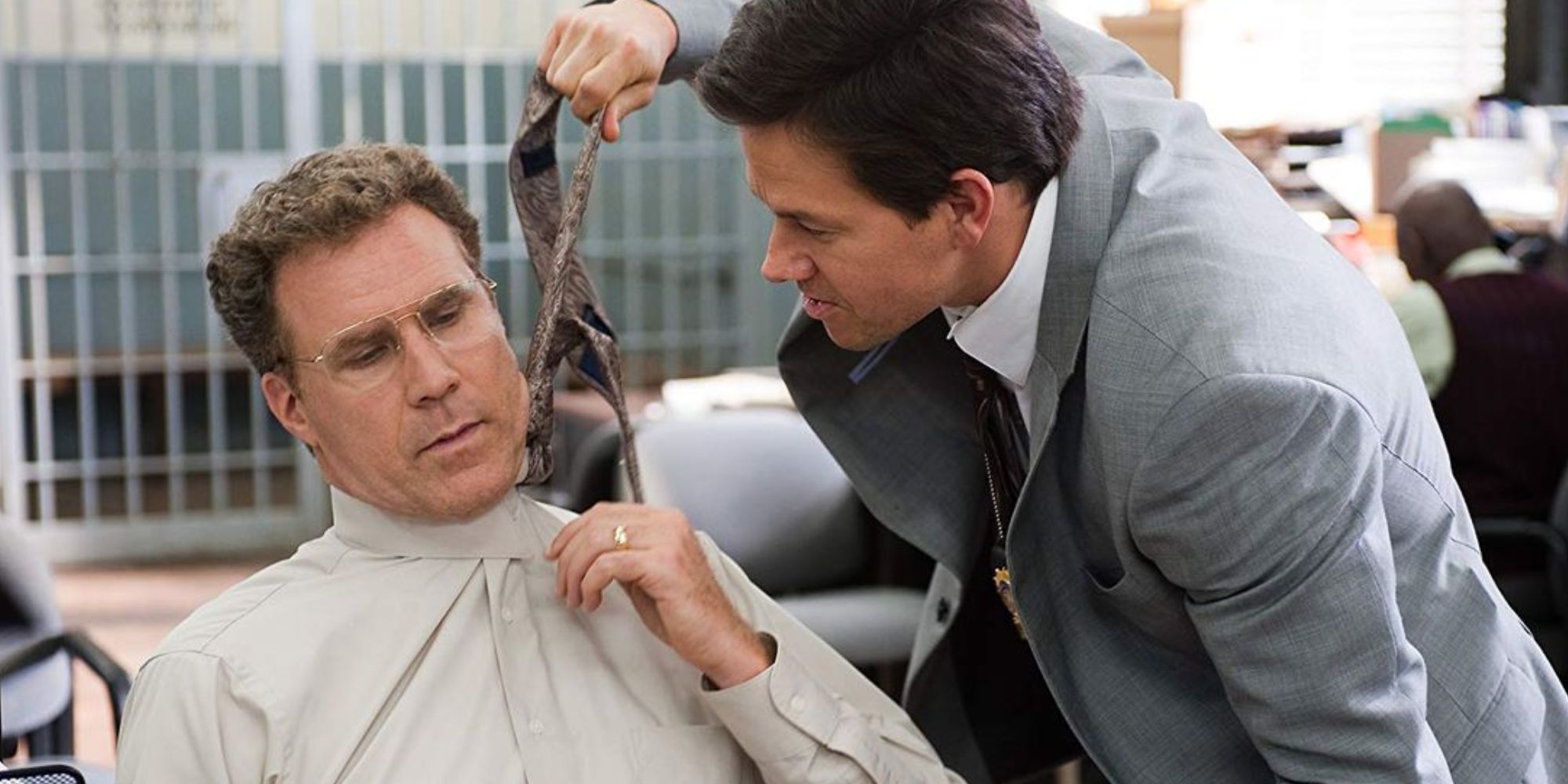 Will Ferrell as Allen Gamble having his tie pulled by Mark Wahlberg as Terry Hoitz in The Other Guys