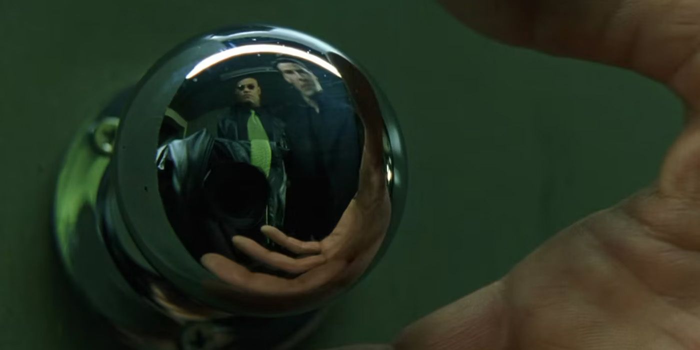 A doorknob reflects Morpheus and Neo in The Matrix