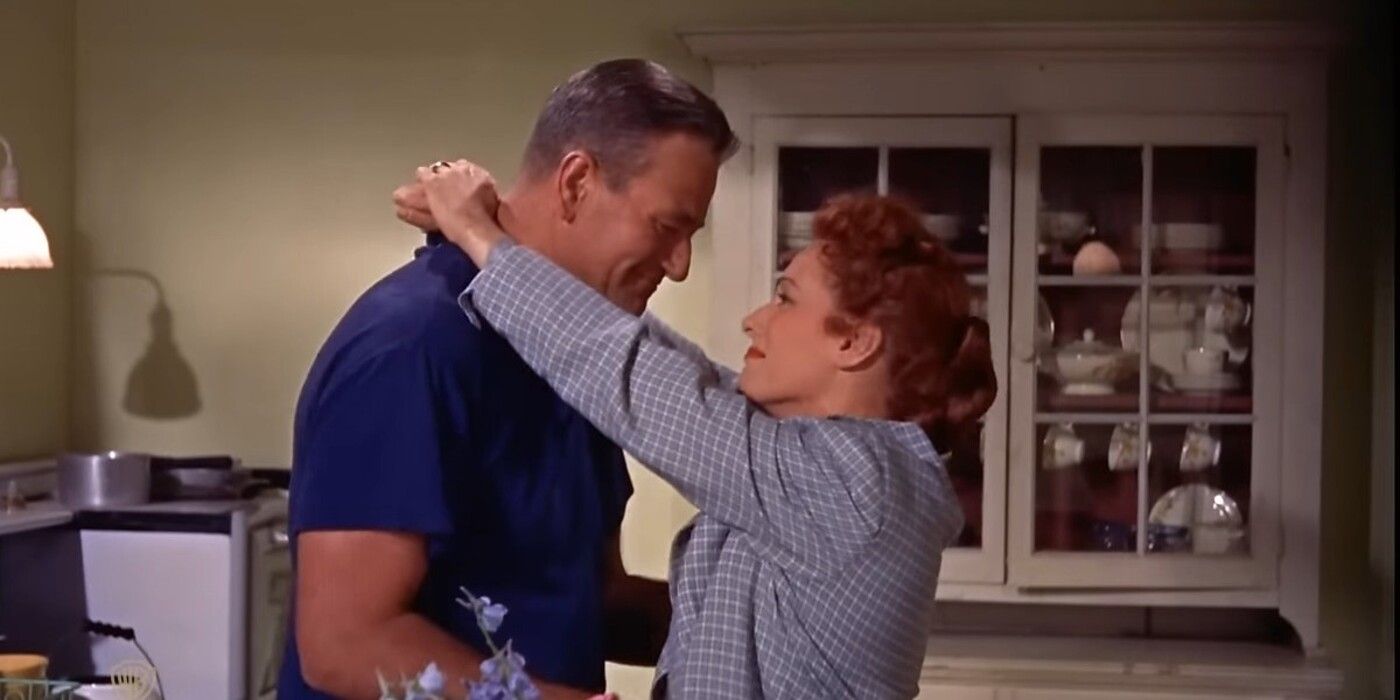 John Wayne as Frank "Spig" Wead and Maureen O'Hara as Min Wead embrace for a kiss in The Wings of Eagles 