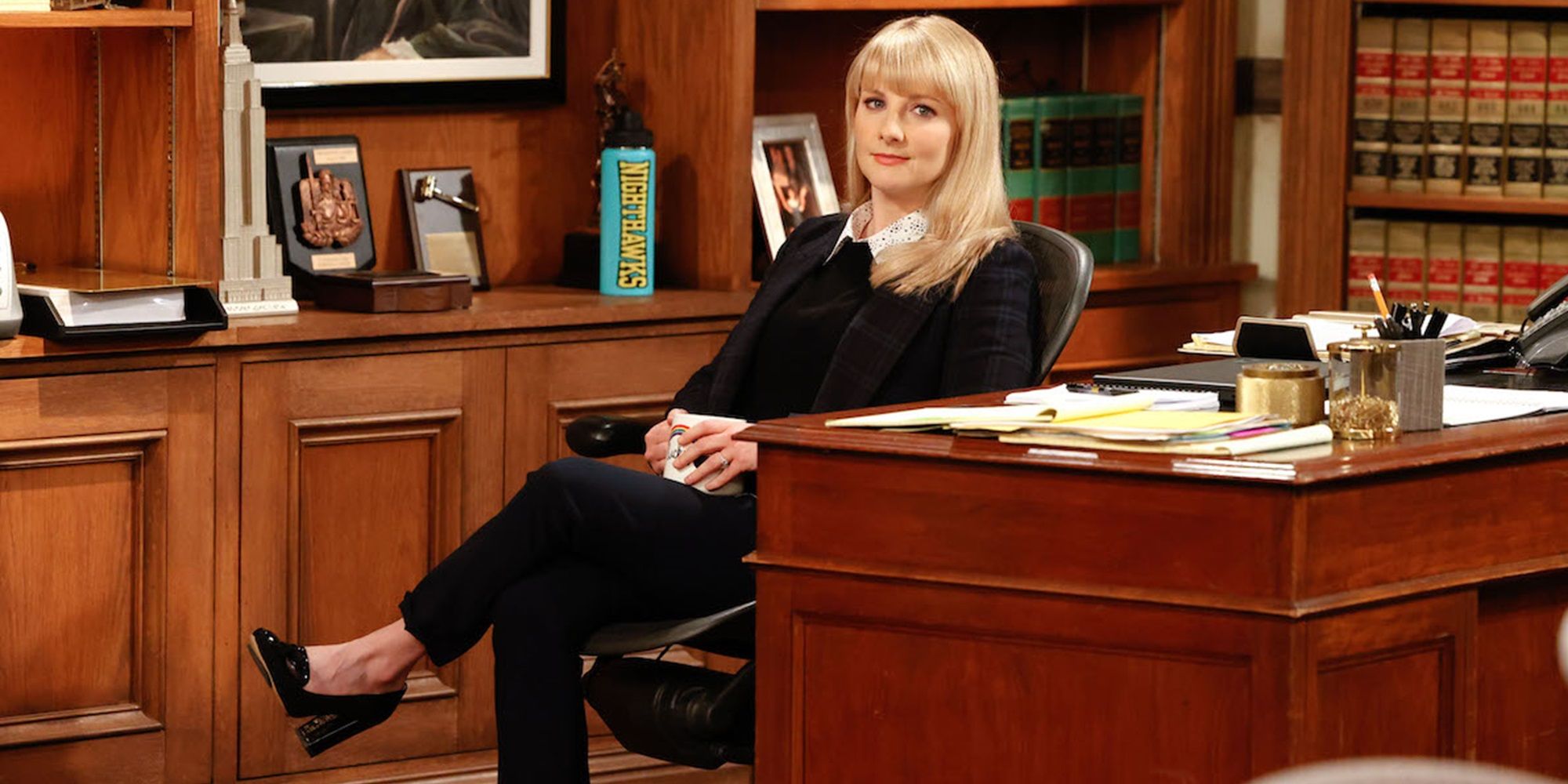 Abby sits behind her desk in Night Court