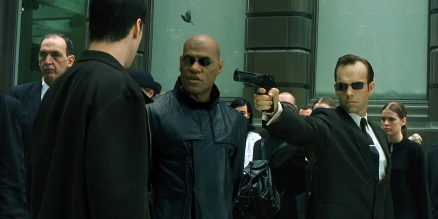 Agent Smith points a gun at Neo in The Matrix