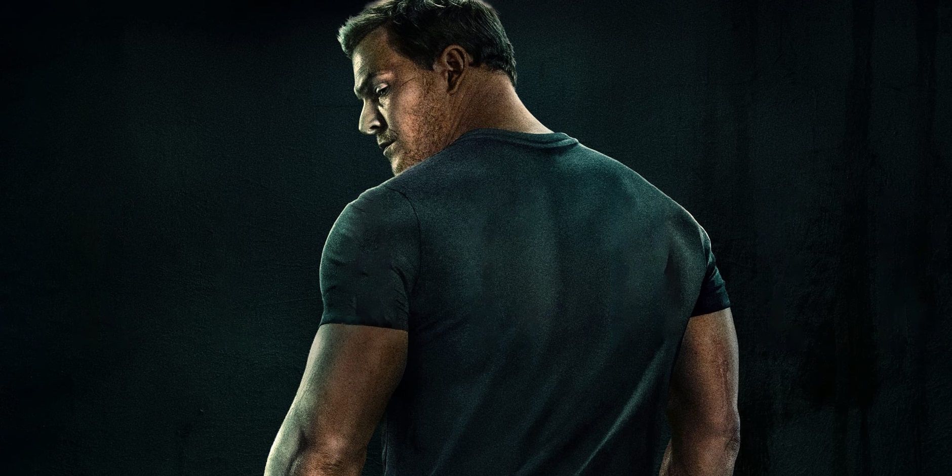 Alan Ritchson looking over his shoulder on the poster for Reacher season 2