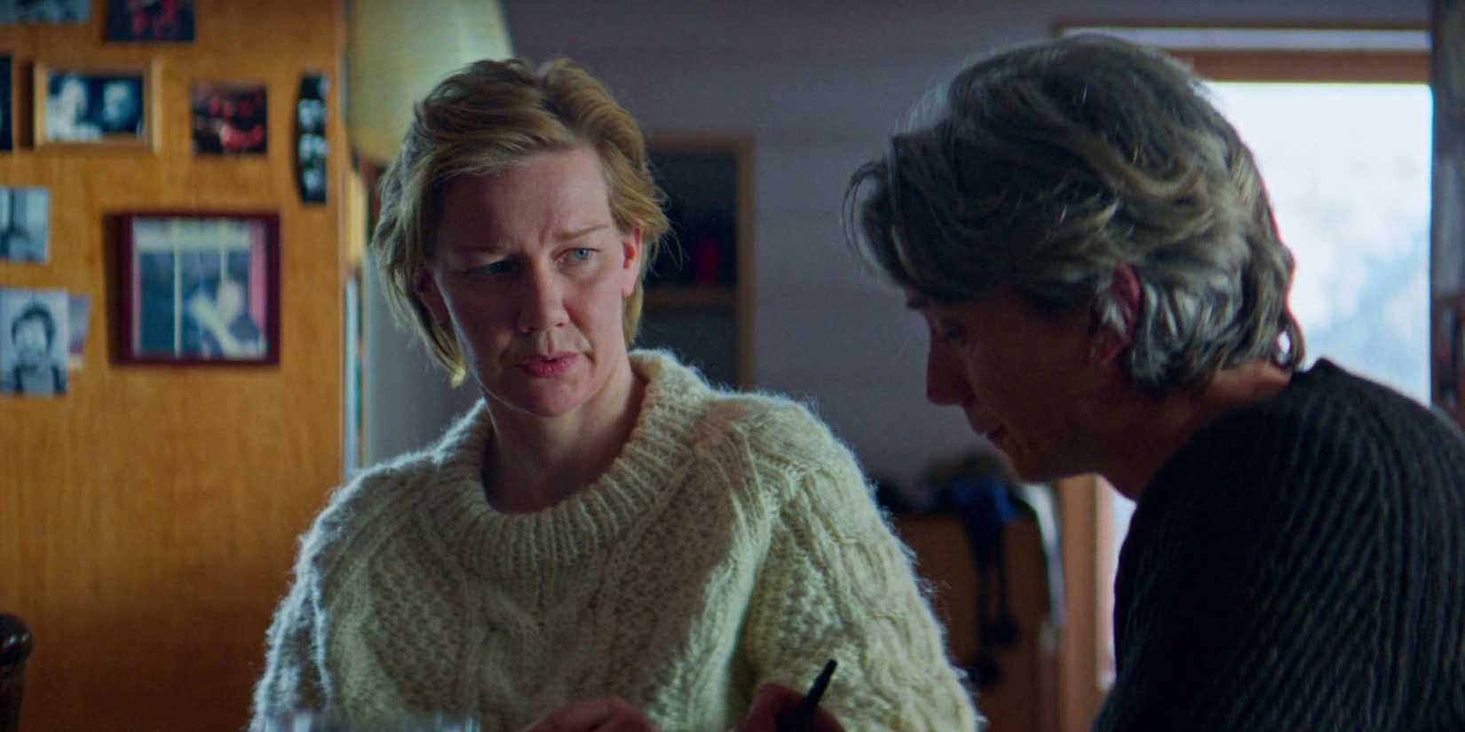 Sandra (Sandra Huller) and Vincent (Swann Arlaud) sitting and talking in Anatomy of a Fall