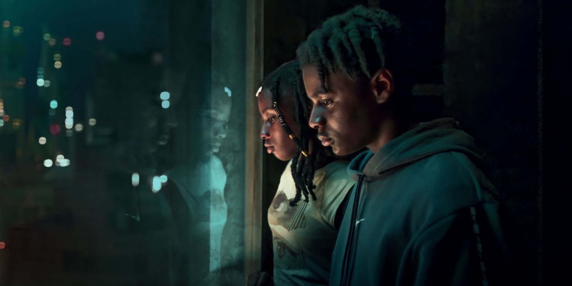 Benji and Ruby stare out a high-rise window