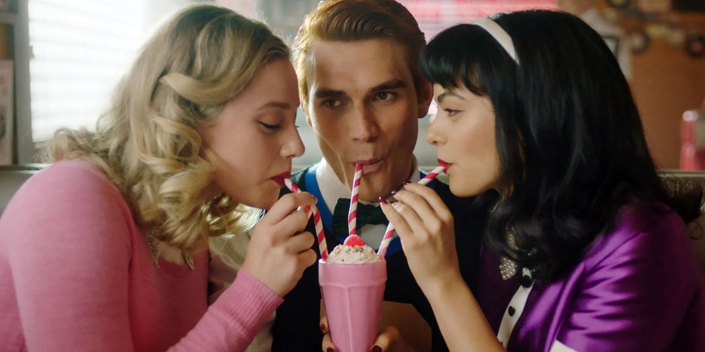 Betty, Archie and Veronica share a milkshake in Riverdale
