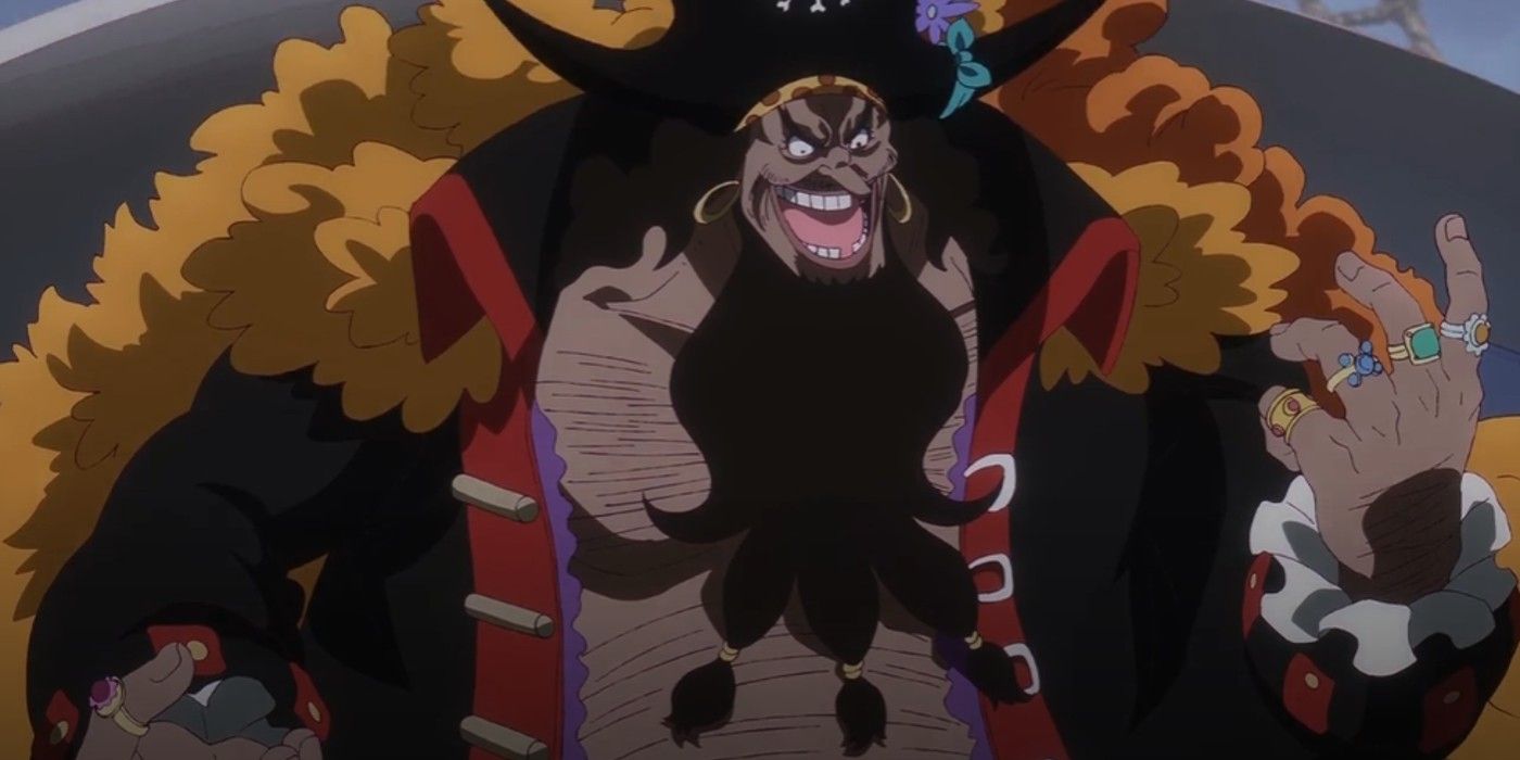 Blackbeard smiling threateningly in One Piece looking at his hand full of rings