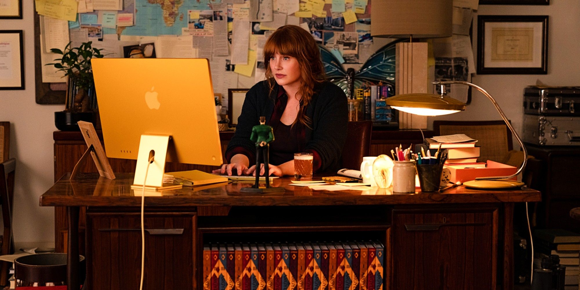 Bryce Dallas Howard As Elly Conway Sitting At Her Desk Writing On Her Computer In Argylle