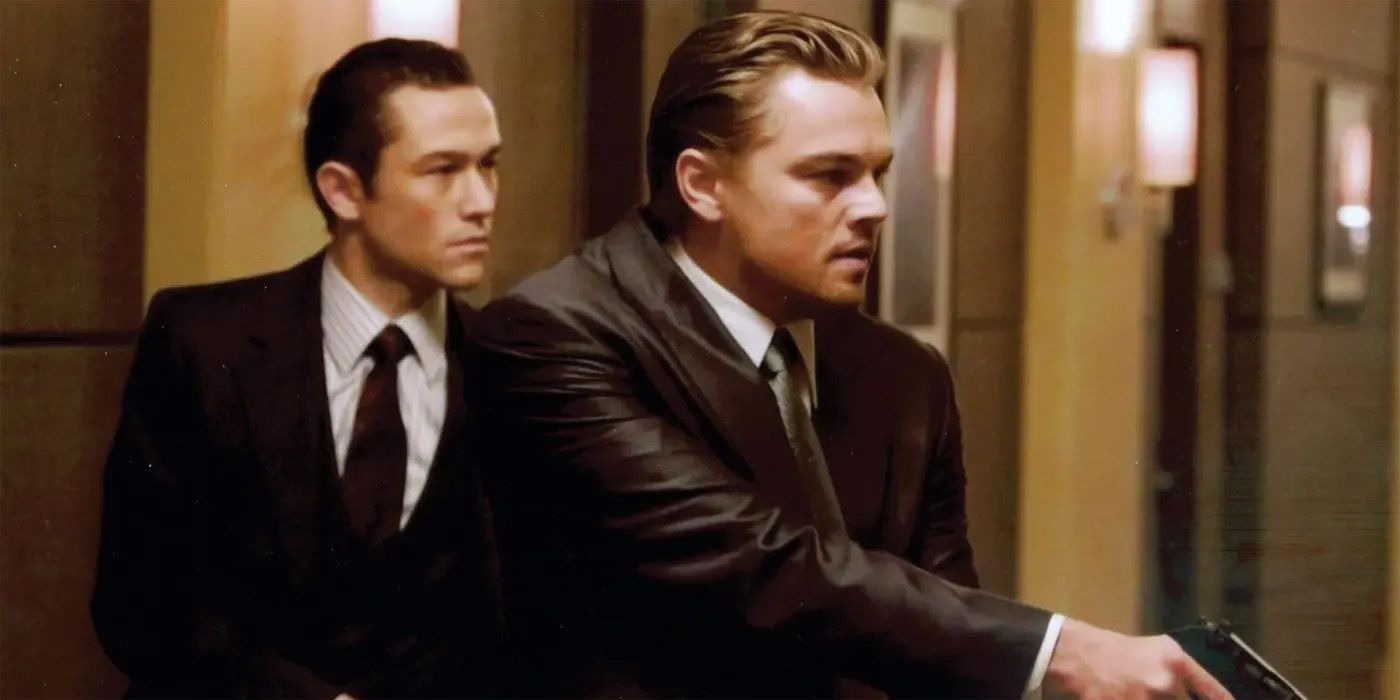 Cobb and Arthur with guns in Inception