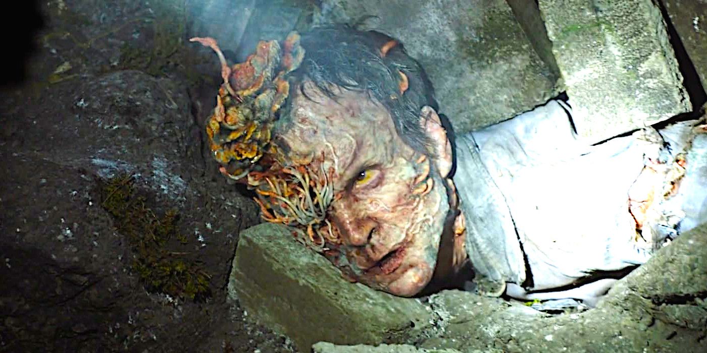 Cordyceps zombie with bizarre fungal forms growing out of its face lies pinned under rubble in The Last of Us season 1