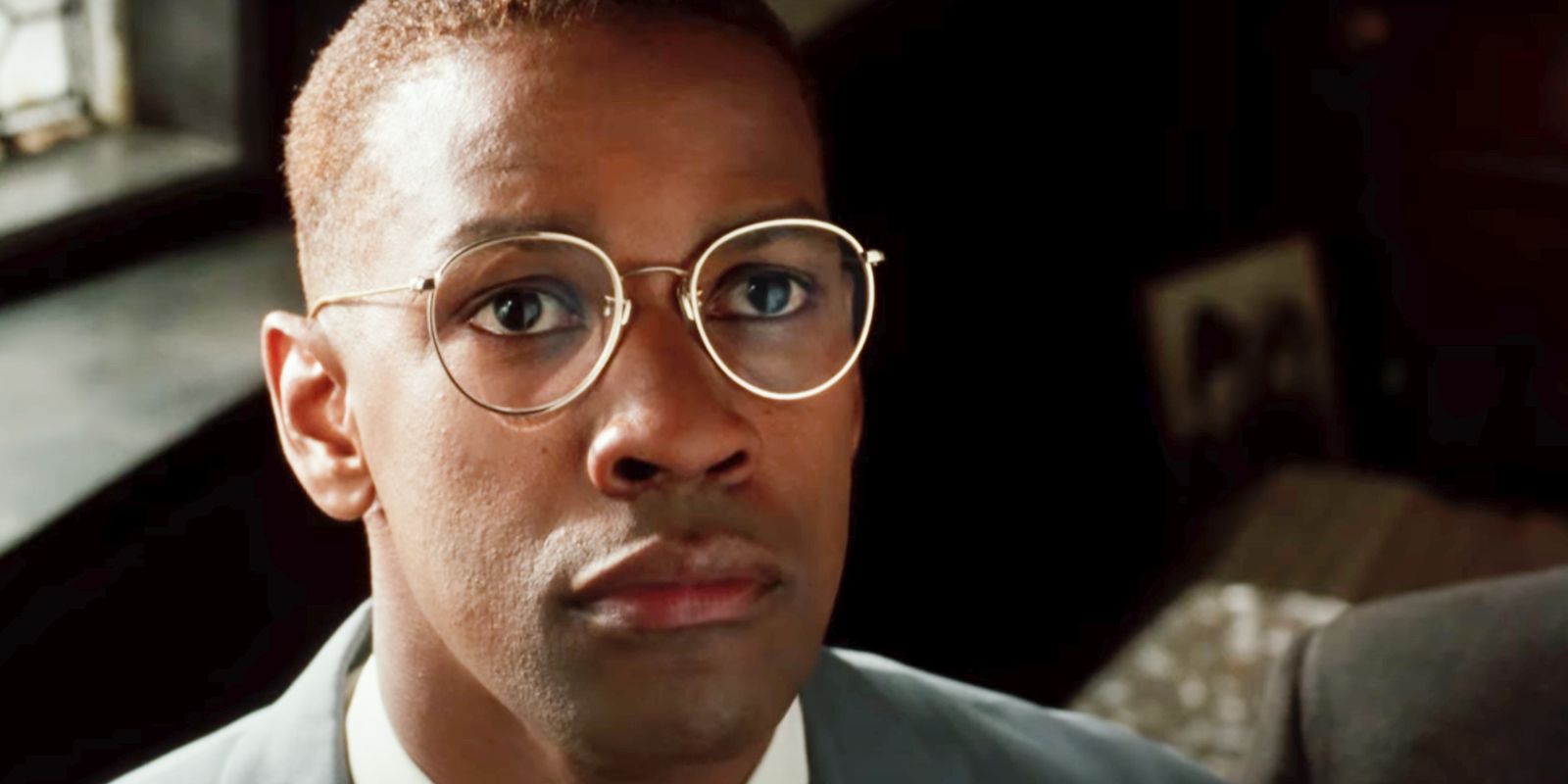 Denzel Washington's Malcolm X in glasses looking up in Malcolm X