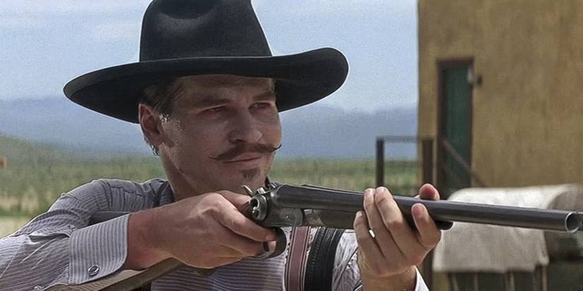 Doc Holliday (Val Kilmer) aims a gun in Tombstone.