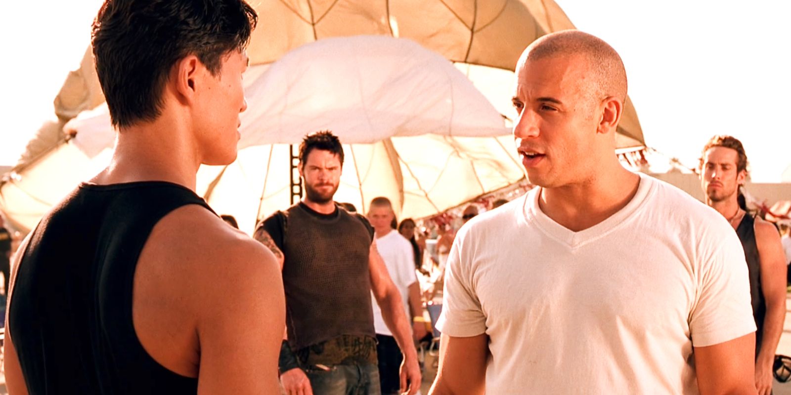 Dominic Toretto talking to Johnny Tran in front of crew in The Fast and The Furious