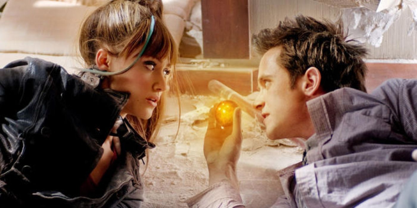 Goku (Justin Chatwin) and Bulma (Emmy Rossen) with a dragon ball in Dragonball Evolution