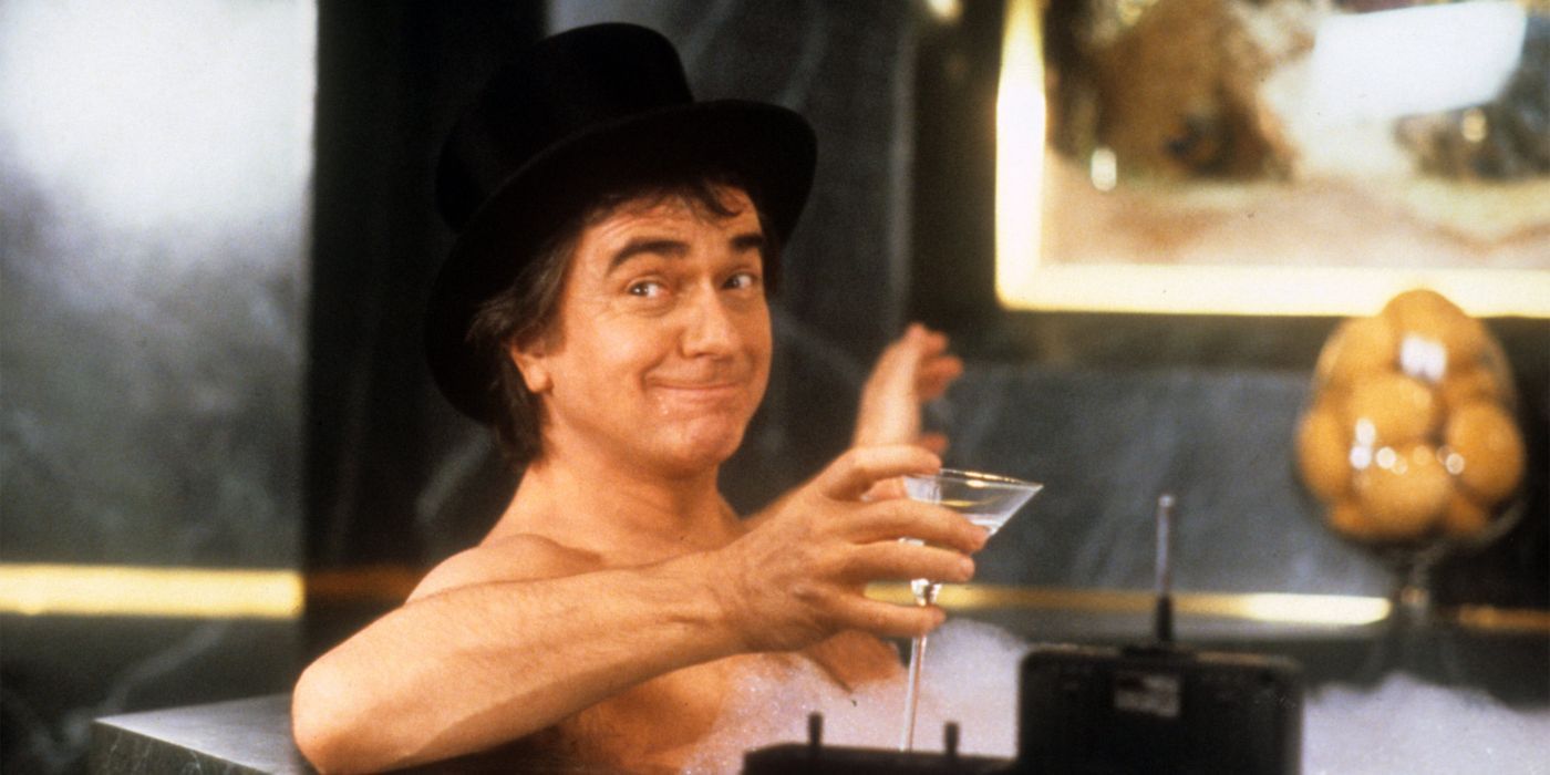 Dudley Moore as Arthur Bach sitting in a bathttub drinking a martini in Arthur.