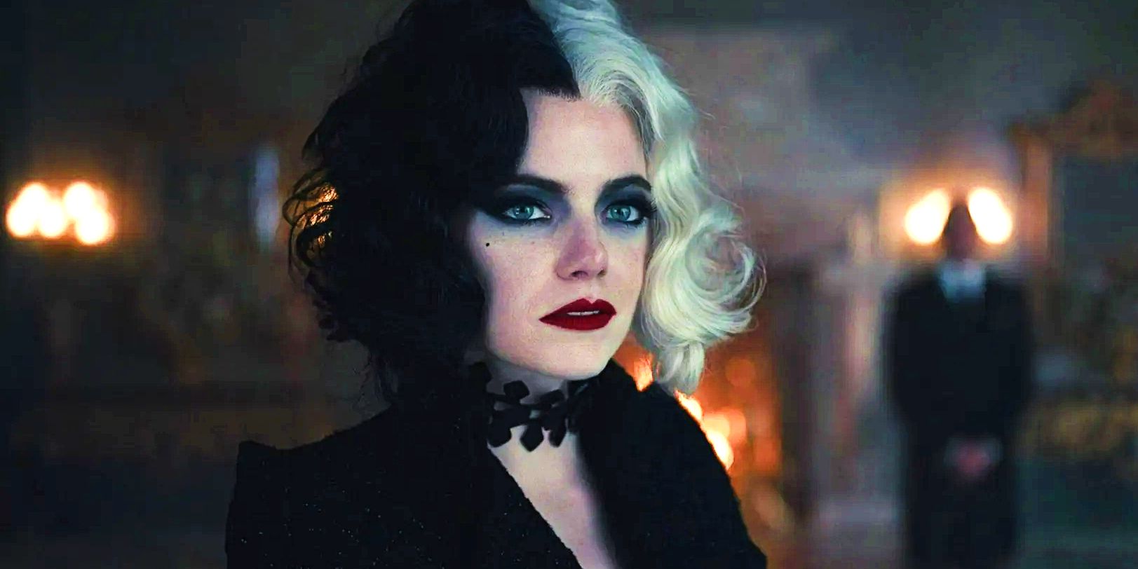 Emma Stone in close-up looking into the distance in Cruella