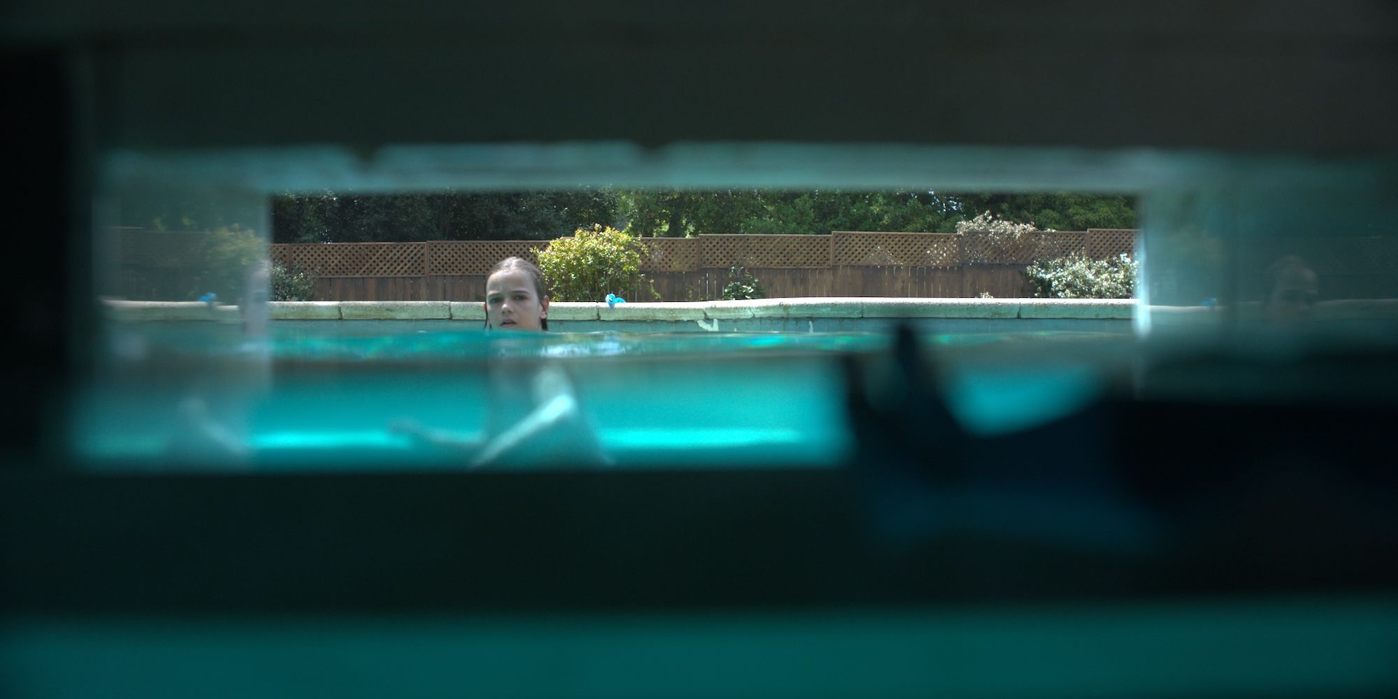 Gavin Warren stares at a pool spirit in Night Swim