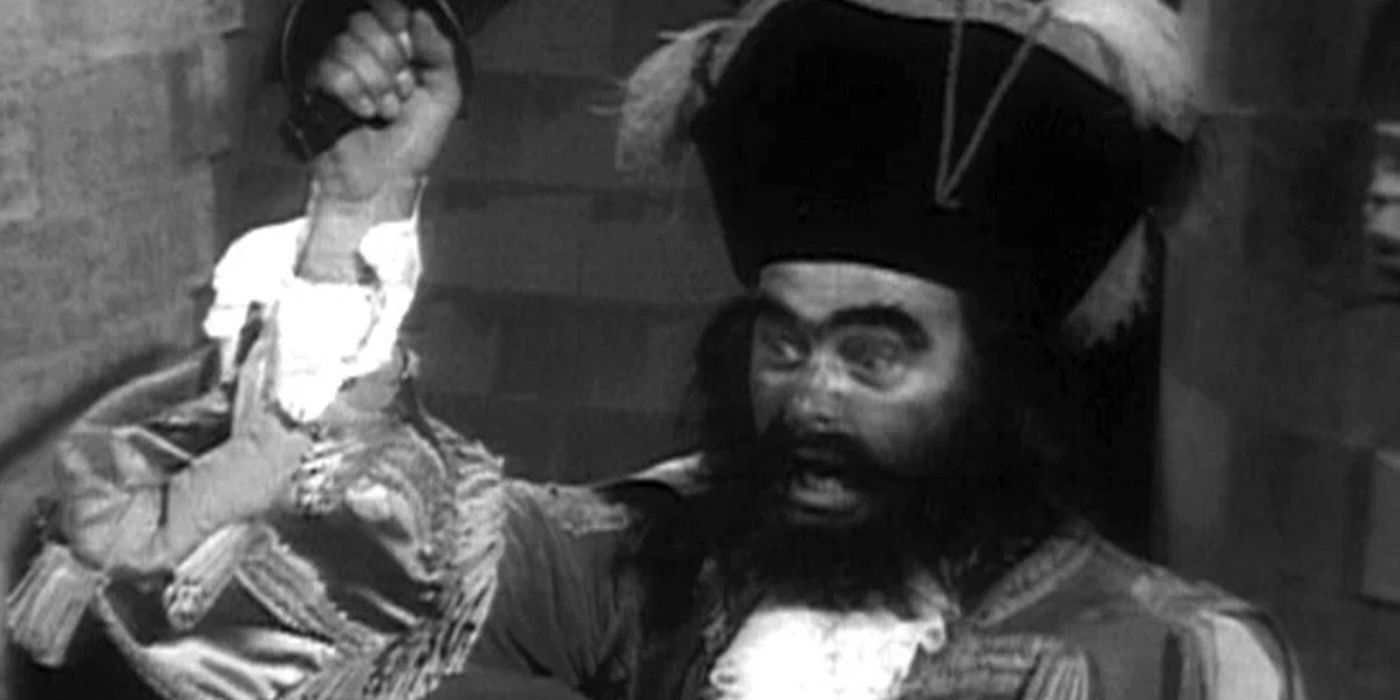 Gerry Wain as Blackbeard holding up a sword in Doctor Who