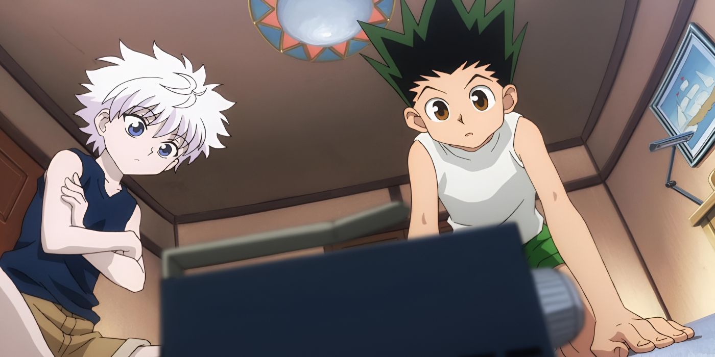 A boy with fluffy white hair and a boy with spiky black hair curiously look down at a box.