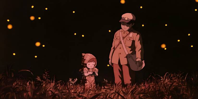 Seita and Setsuko stand in a field at night with fireflies from Grave of the Fireflies.