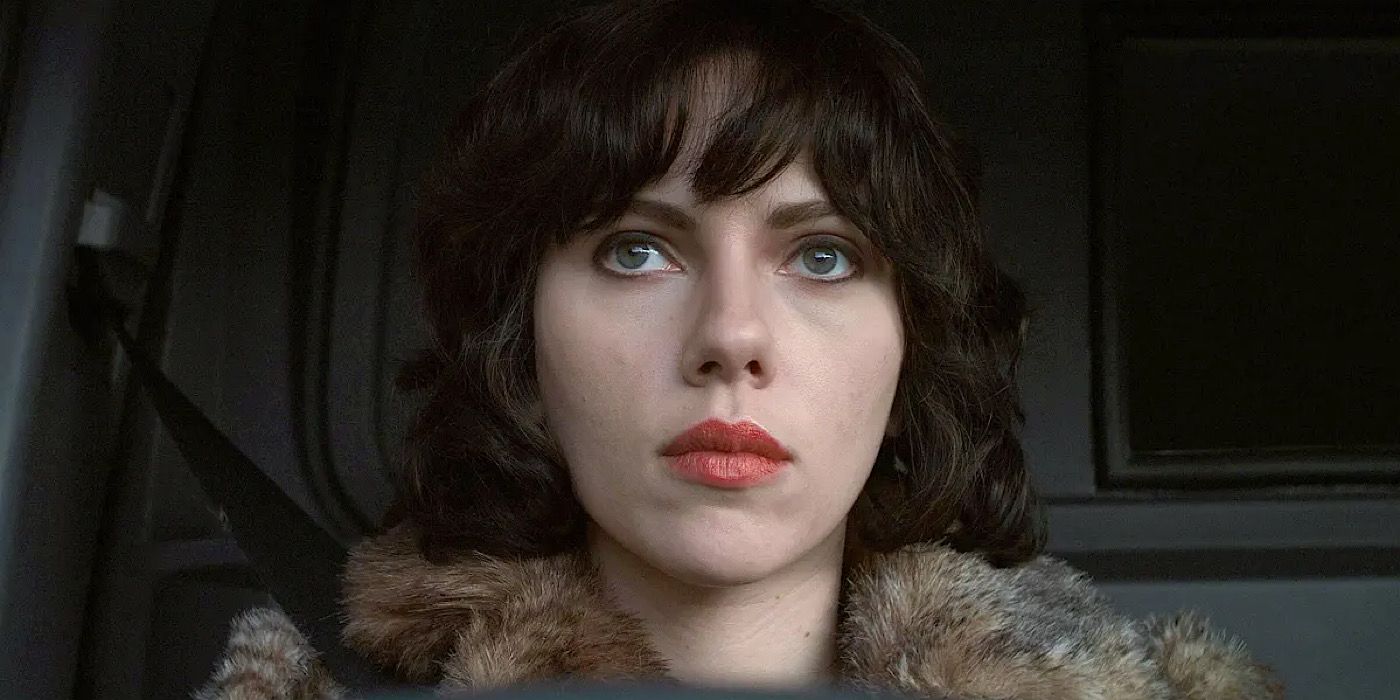 Laura looks up with a cold look on her face in Under the Skin.