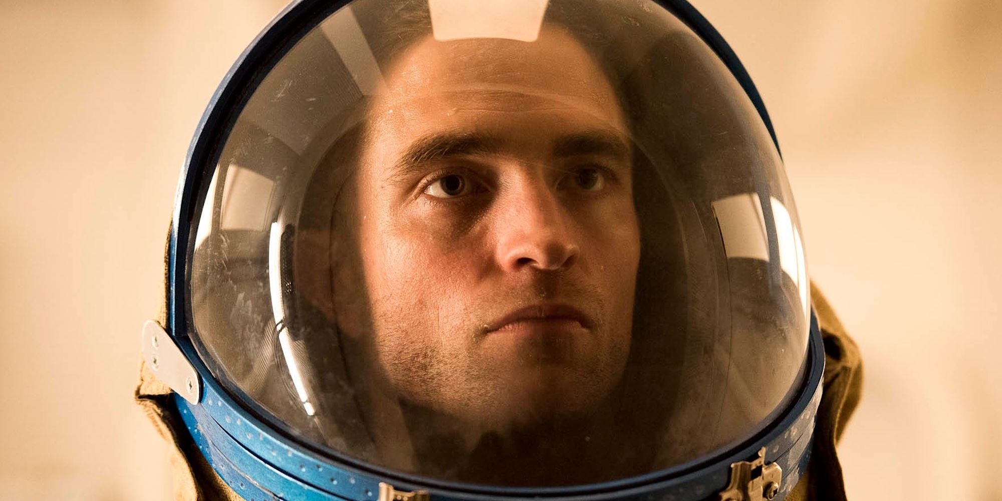Monte is in his space helmet with a stern look on his face in High Life.