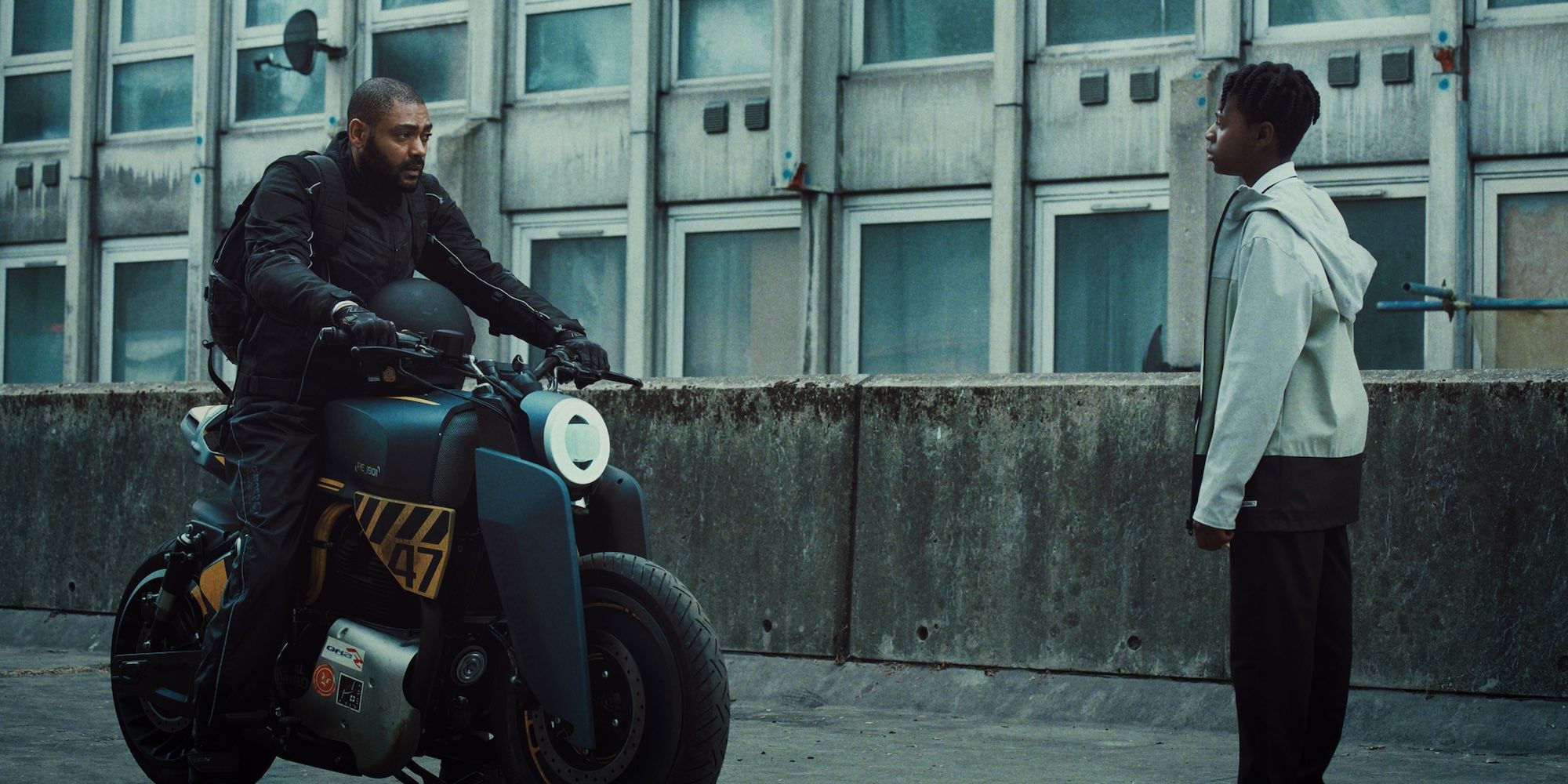 Izi on his motorcycle talks to Benji during a meet up in The Kitchen