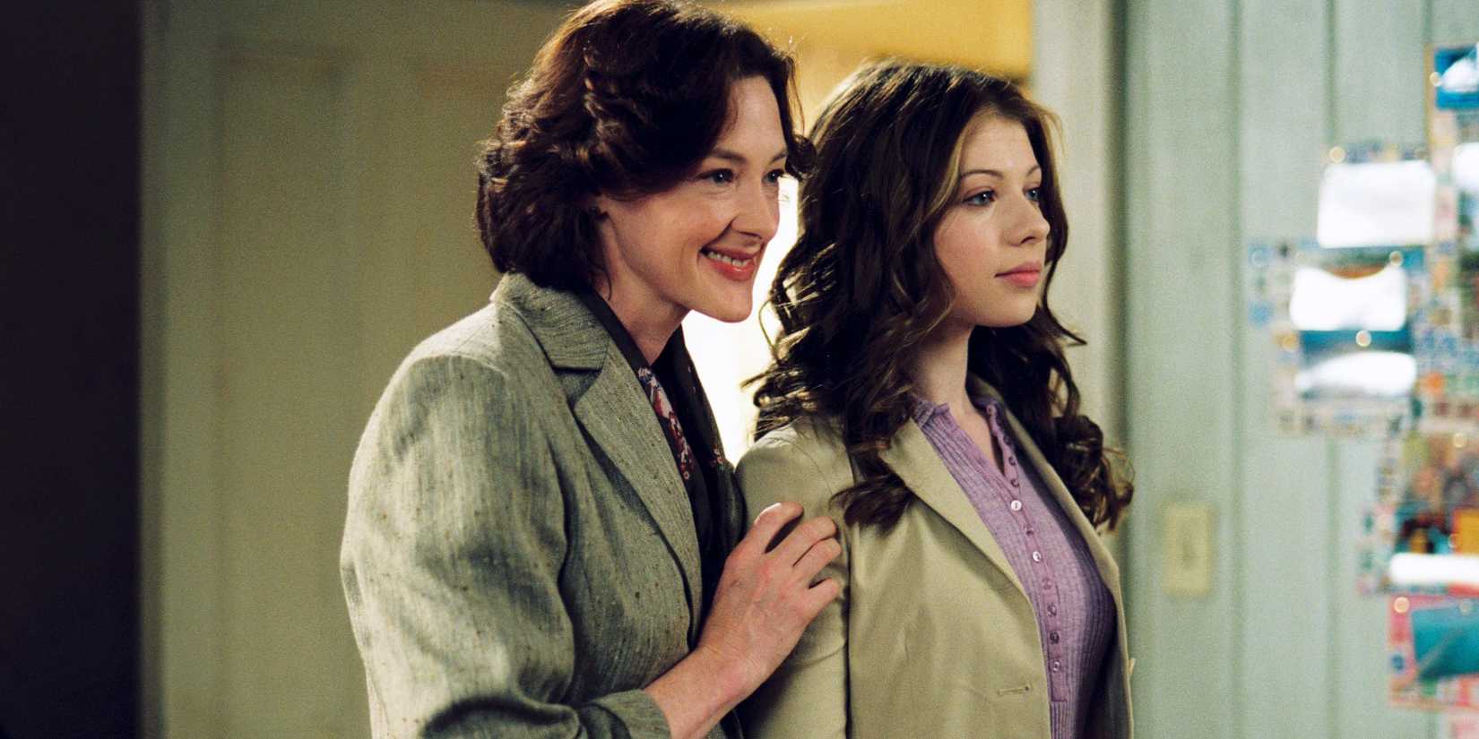 Joan Cusack standing behind Michelle Trachtenberg in Ice Princess