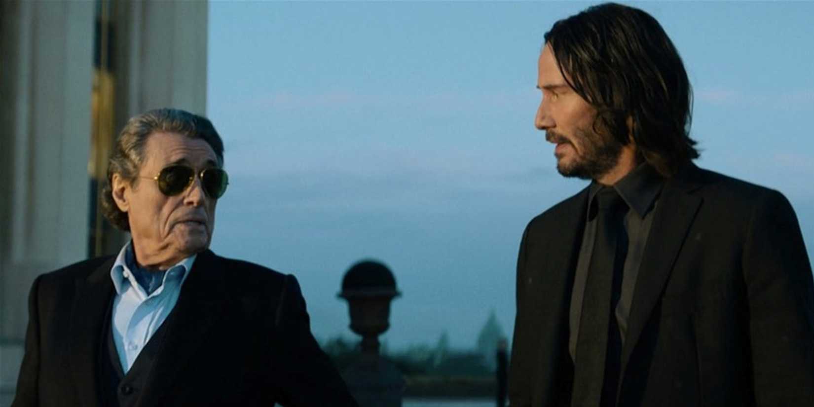 John (Keanu Reeves) talking to Winston (Ian McShane) in John Wick Chapter 4