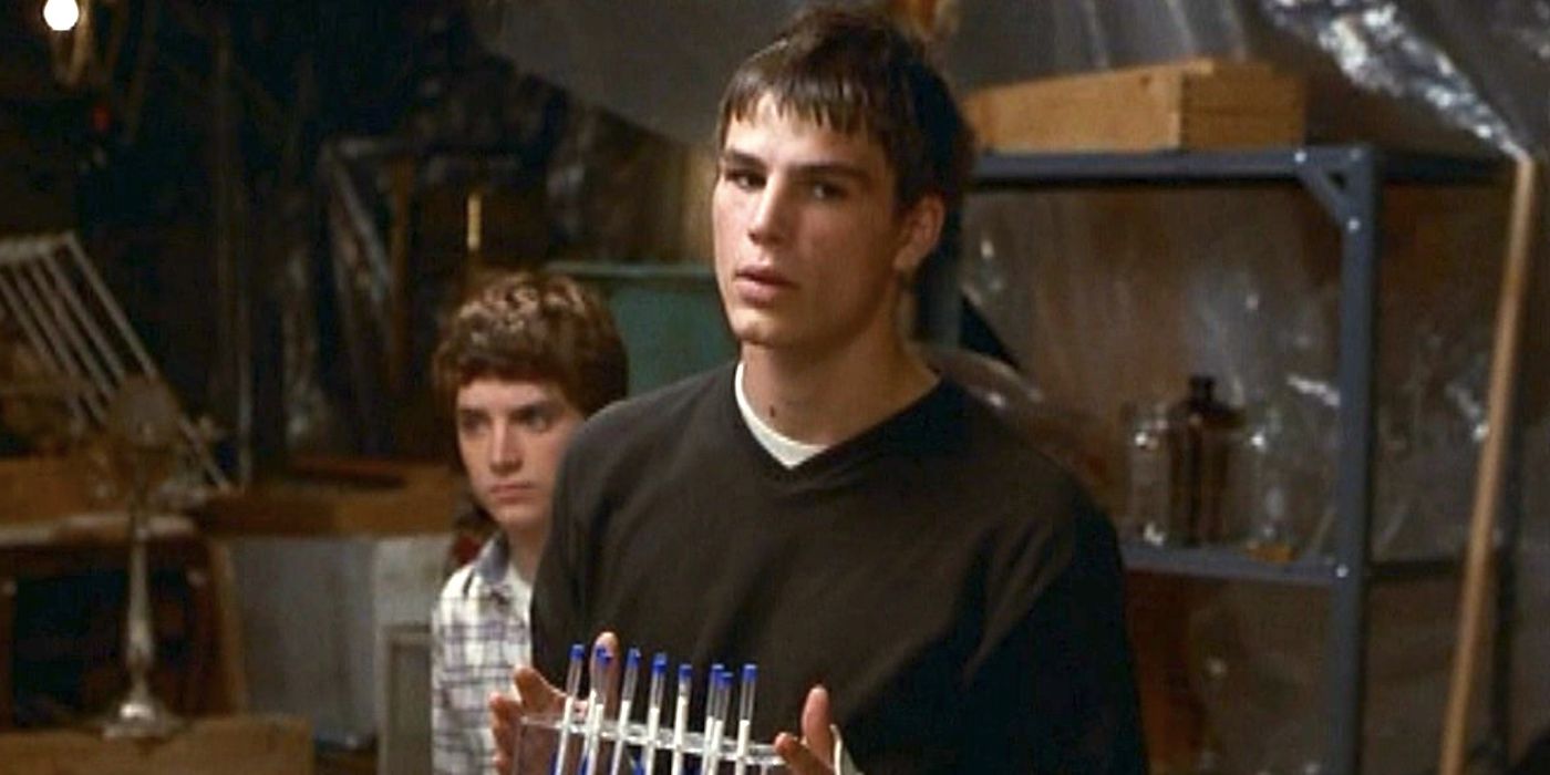 Josh Hartnett's Zeke holds up pens with Elijah Woods's Casey in the background in The Faculty