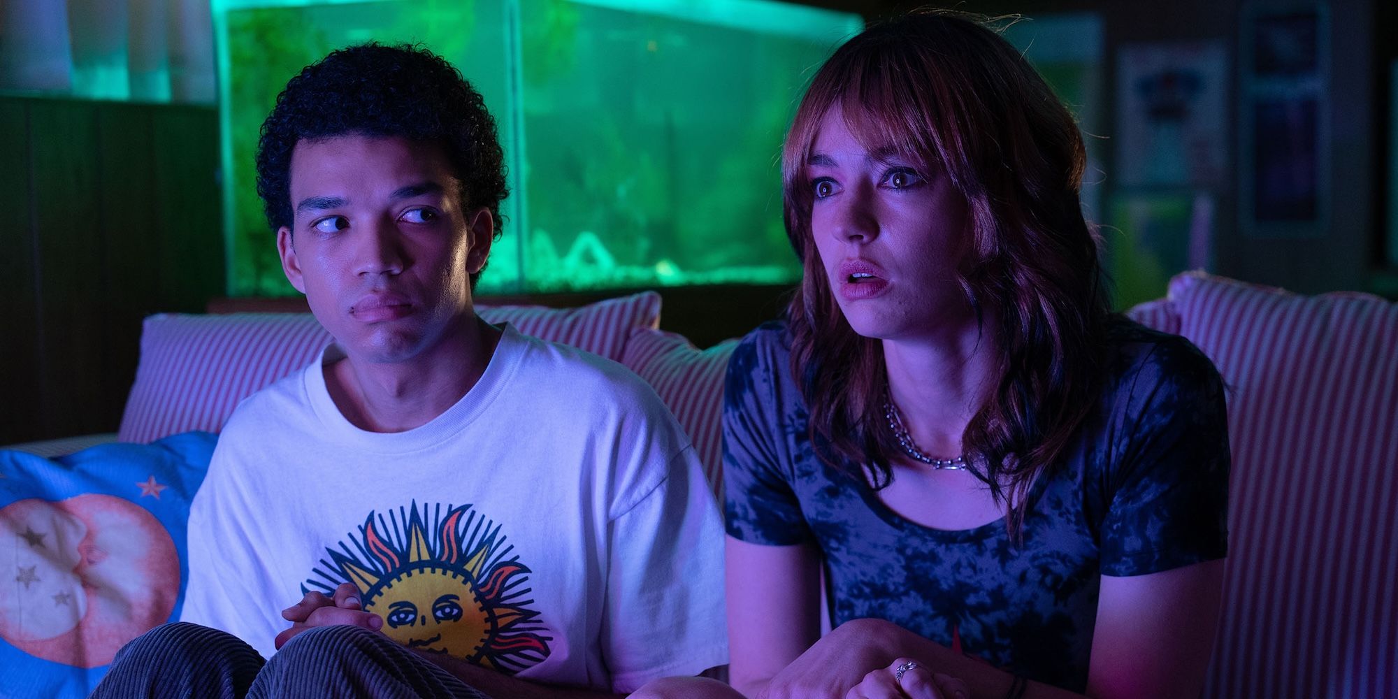 Justice Smith stares at Brigette Lundy-Paine as she looks horrifically at the TV in I Saw the TV Glow