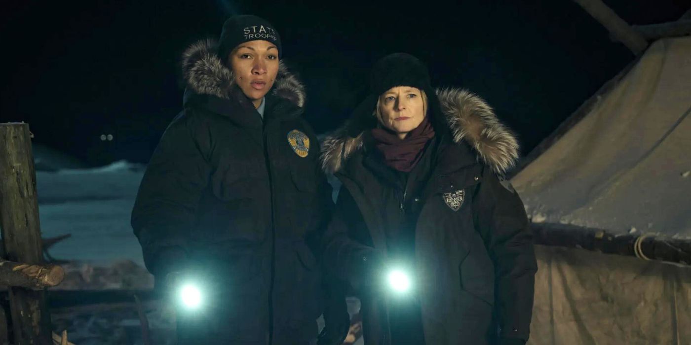 Kali Reis as Navarro and Jodie Foster as Danvers holding flashlights in True Detective season 4