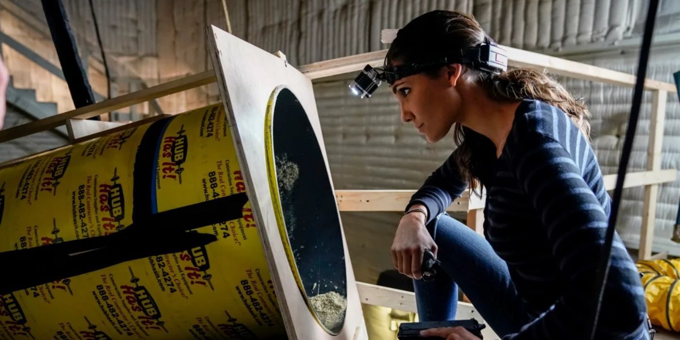 Kensi (Daniela Ruah) kneeling down and looking into a hole in NCIS LA season 9 episode 7.