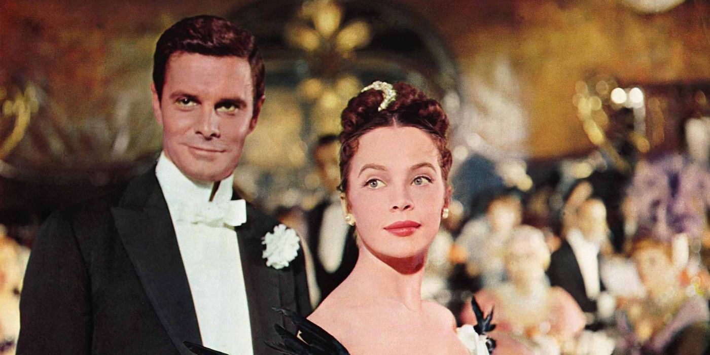 Louis Jourdan as Gaston Lachaille and Leslie Caron as Gigi standing together and smiling at a party in Gigi.