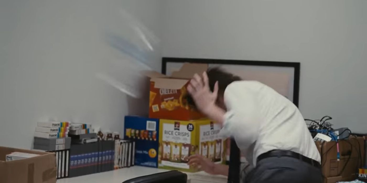 Greg ducks away from a water bottle in Succession season 2