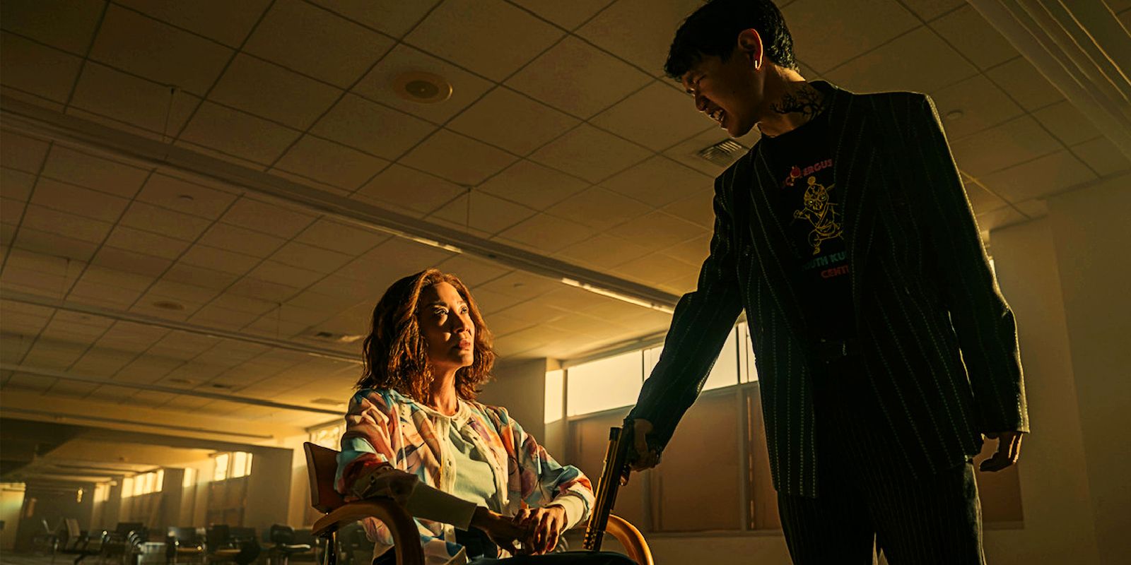 A mom holds a gun to Mama Sun during an interrogation in The Brothers Sun.