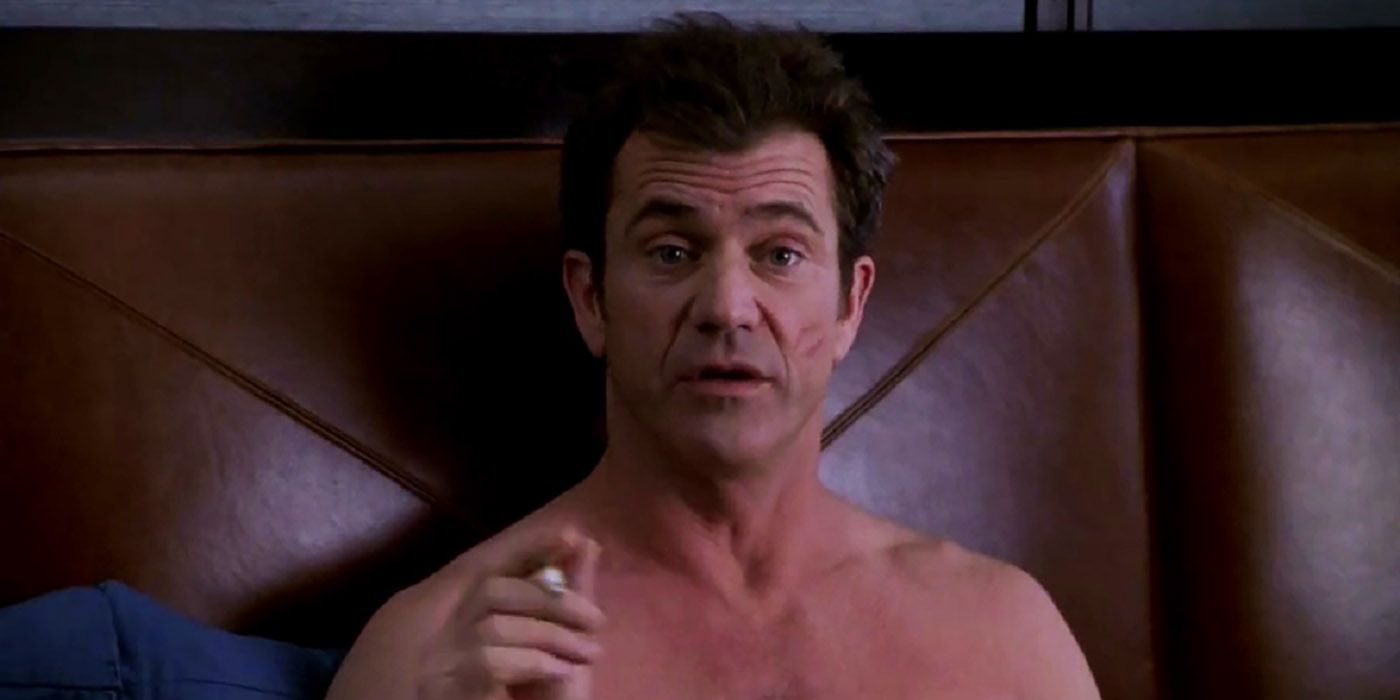 Mel Gibson as Nick in bed with a kiss on his cheek in What Women Want