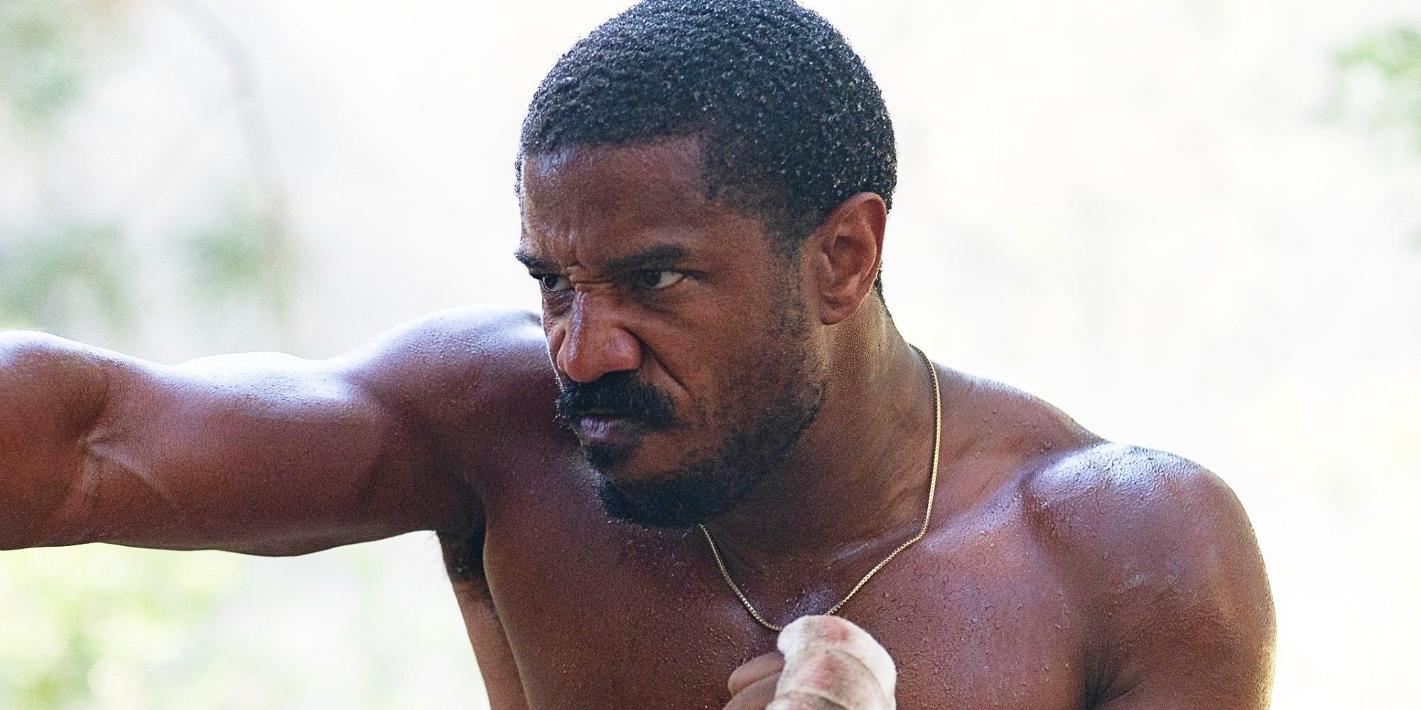 Michael B Jordan as Adonis training with wrapped knuckles in Creed 3