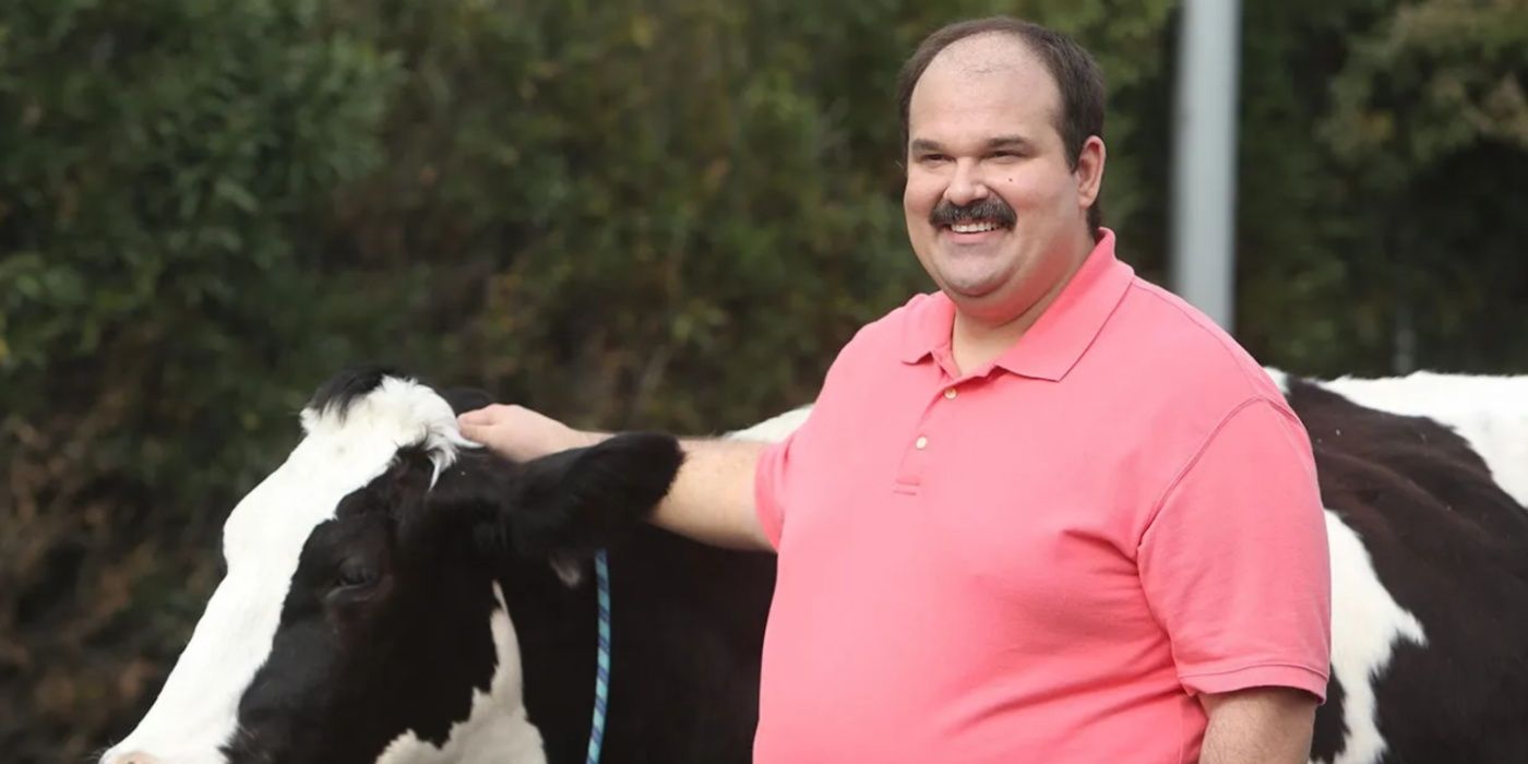 Todd (Mel Rodriguez) stroking a cow in The Last Man on Earth