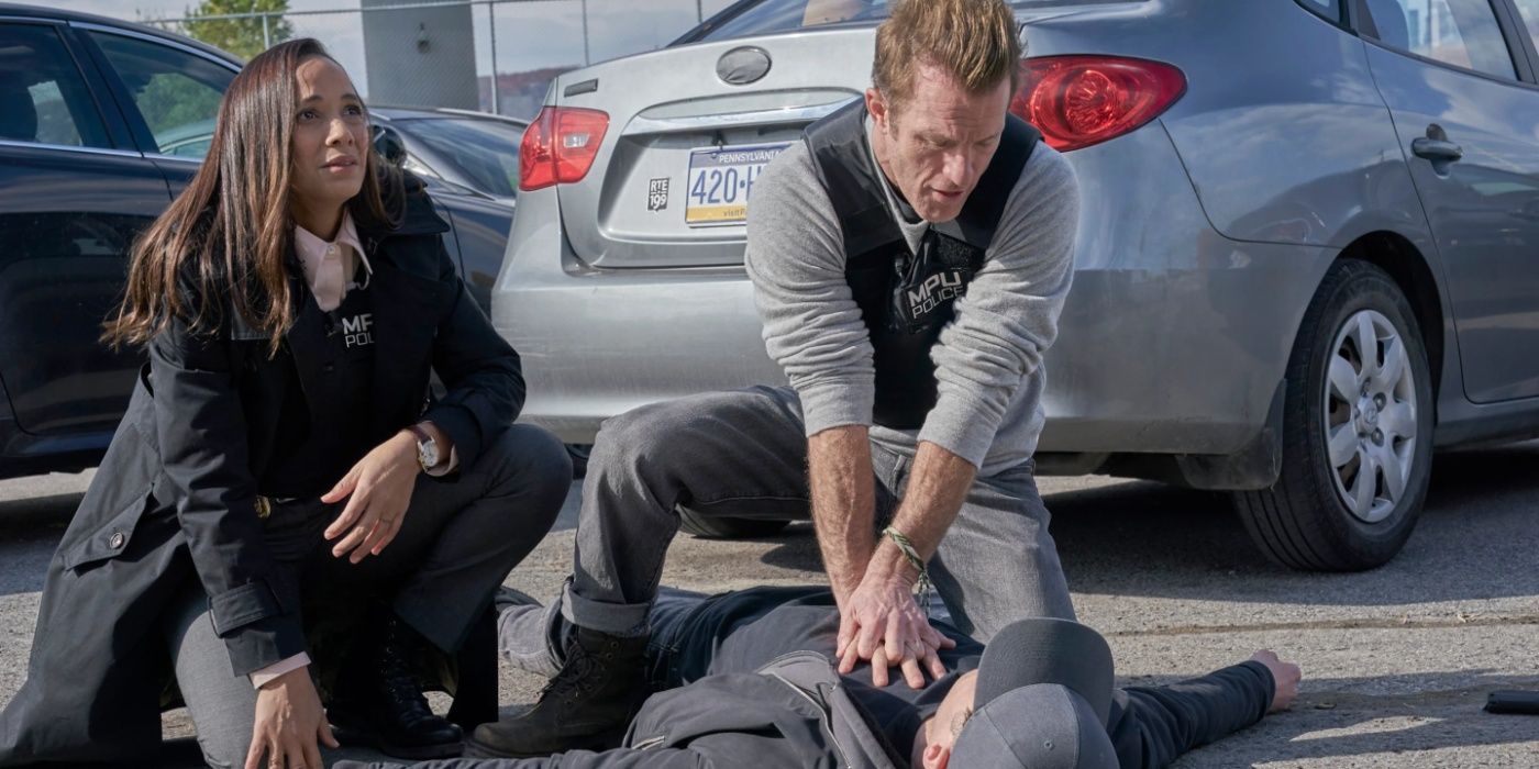 Jason (Scott Caan) and Nikki (Dania Ramirez) attend to an unconscious man in Alert Missing Persons Unit