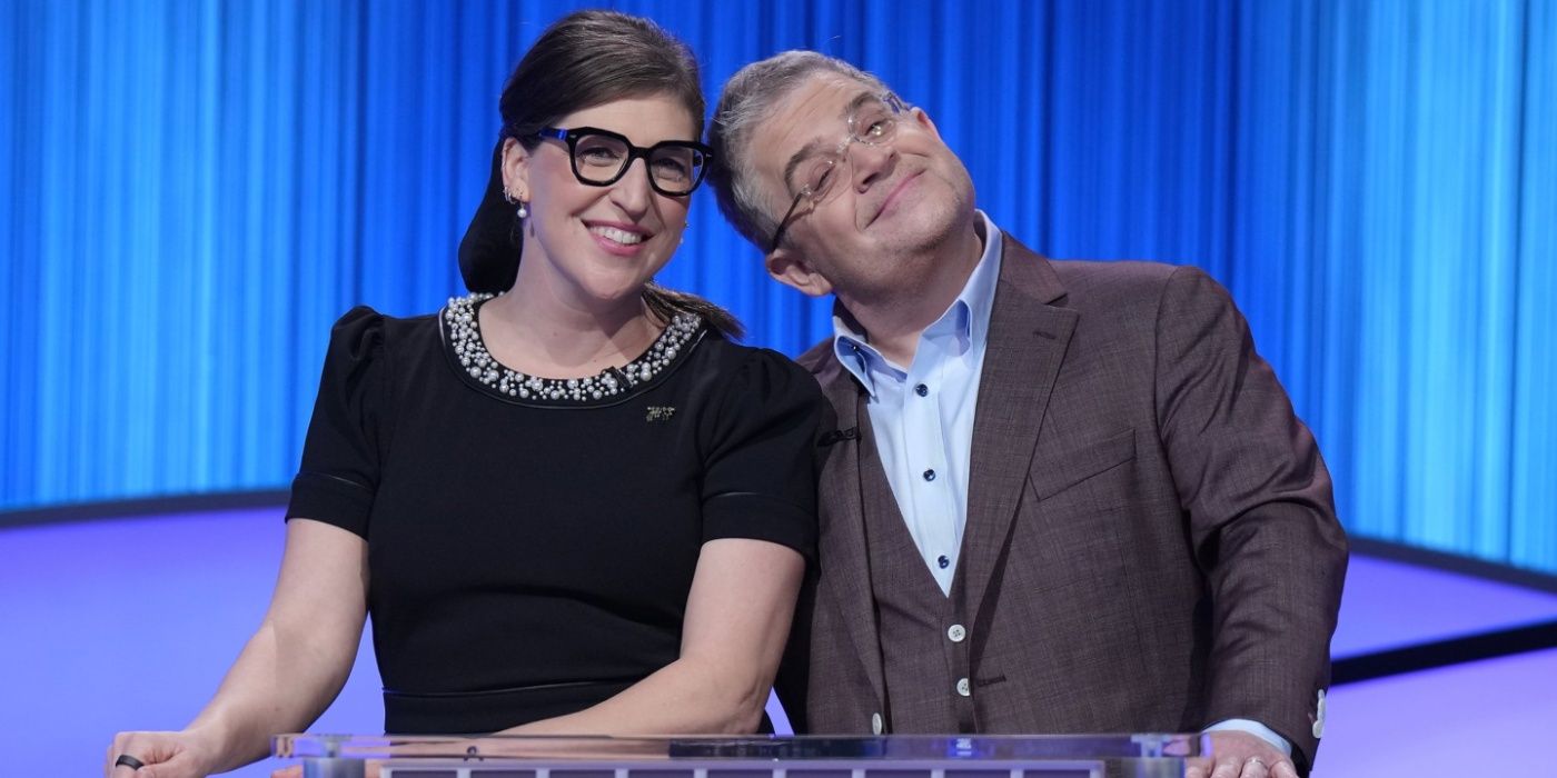Patton Oswalt and host Mayim Bialik smiling on Celebrity Jeopardy