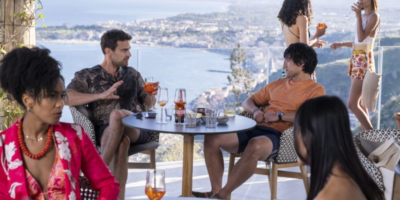 Cameron (Theo James) and Ethan (Will Sharpe) drinking on a balcony in The White Lotus